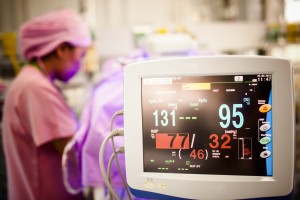 A nurse monitoring a newborn baby